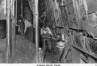 Photo # NH 104090:  Firemen feeding coal to USS Troy's boilers, 1919